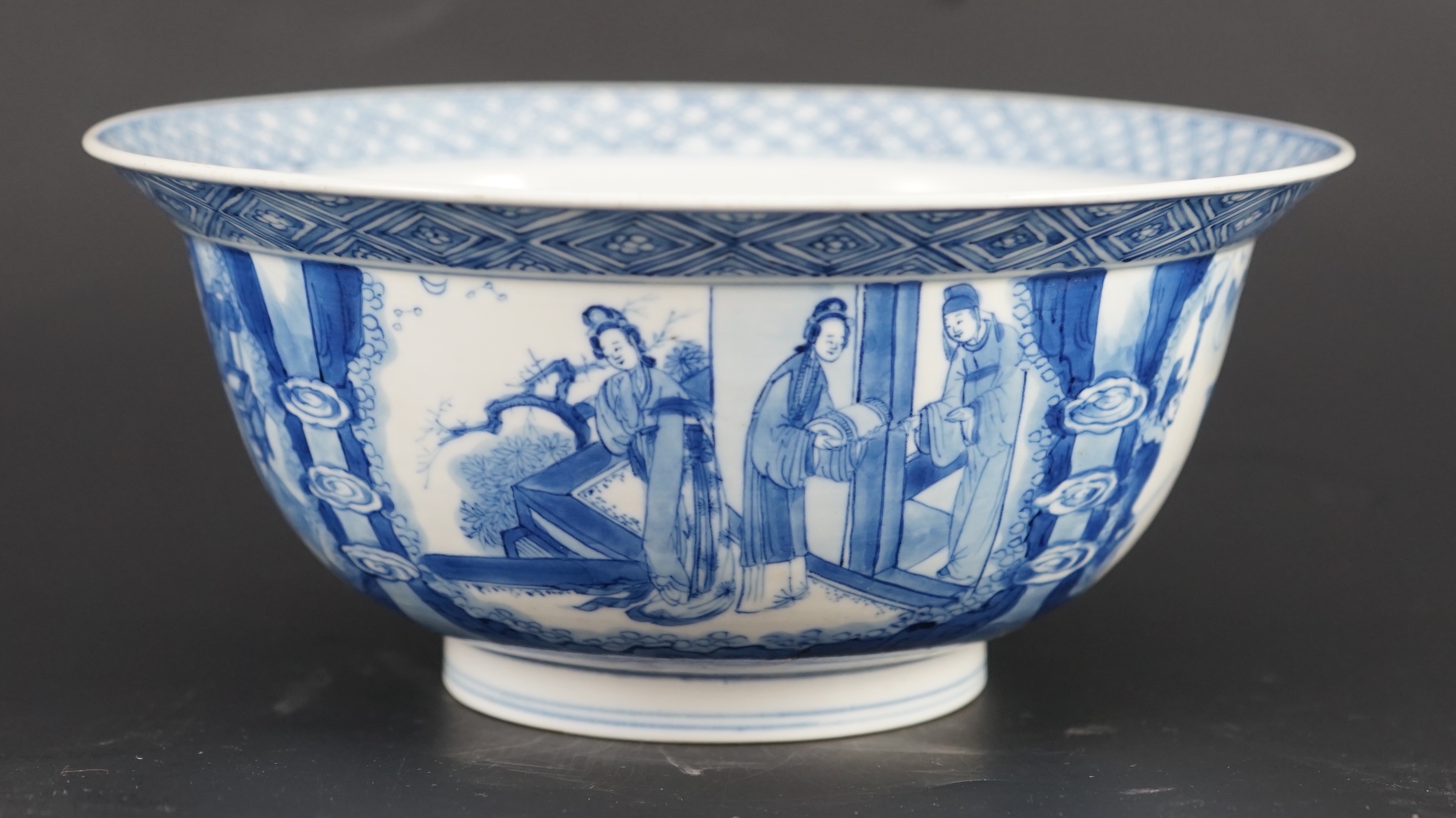 A fine Chinese blue and white ‘Xi Xiang Ji’ bowl, Kangxi six character mark and of the period (1662-1722) 19.9cm diameter, wood stand